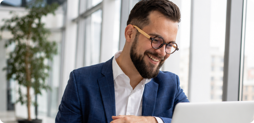 Smiling business owner working on a laptop